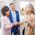 A sister and her husband at a congregation meeting, warmly greeting a woman who was removed from the congregation.