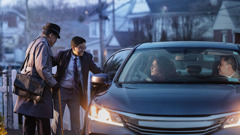 A family picking up an elderly brother to take him to a congregation meeting. Their teenage son helps the brother get in the car.