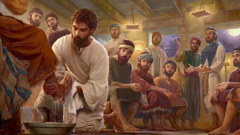 Jesus washing the feet of one of his apostles as the other apostles observe in disbelief.