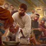 Jesus washing the feet of one of his apostles as the other apostles observe in disbelief.