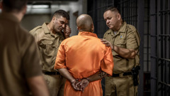 A reenactment of Jack being led away by saddened prison guards. One of the prison guards wipes away tears from his eyes.