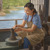 A sister molding clay on a potter’s wheel in her workshop.