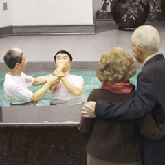 Two of Jehovah’s Witnesses watching their student get baptized