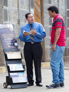 Un frère prêche en utilisant un présentoir mobile