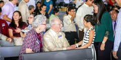 Denton and Janet Hopkinson preach to a woman