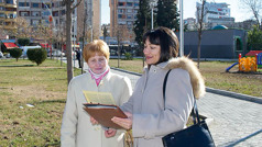 Laura preaching to a woman in a park.
