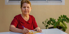 Maria Lúcia écrit une lettre.
