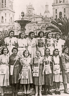 A group of sisters wearing magazine bags over their shoulders.