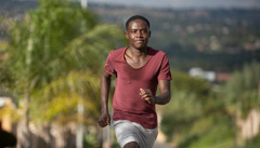 A teenage boy jogging.