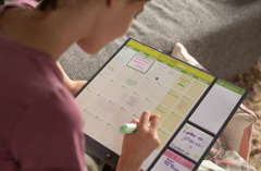A teenage girl writing her Bible reading schedule on a calendar.