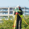 A surveyor inspecting and recording the landscapers’ work.