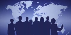 A silhouette of people in front of a world map.