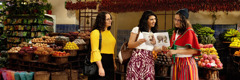 Two Witnesses offering the brochure “Enjoy Life Forever!” to a woman in a local market.