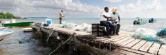 A Witness showing a Bible verse to a man on a fishing pier.