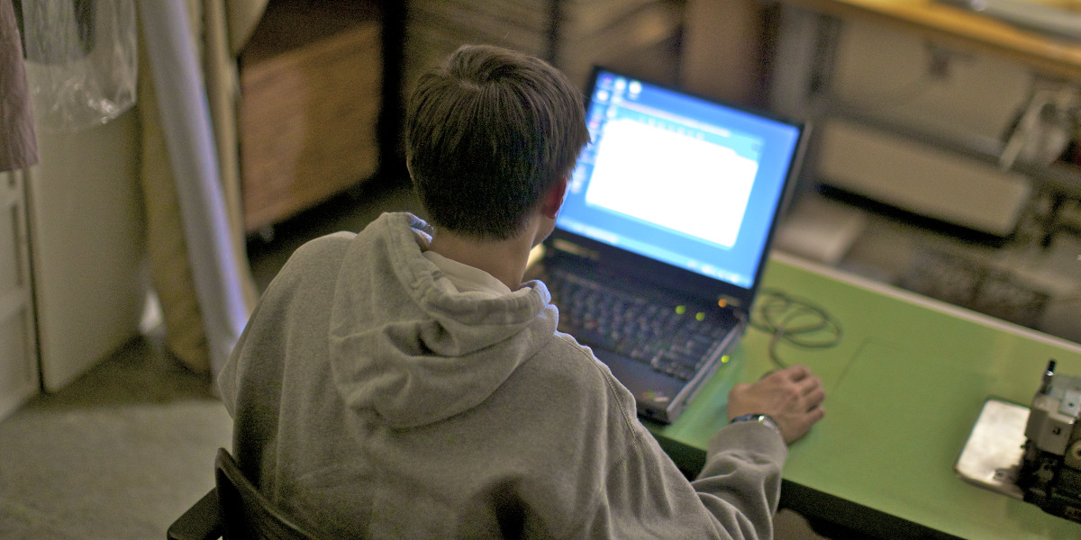 A teenage boy viewing pornography on the Internet