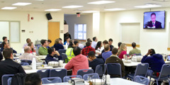 Volunteer workers watching a discussion of a Bible text