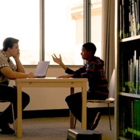 A young man explaining why he believes in God to a fellow student