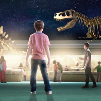 Students in a museum looking at dinosaur fossils