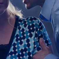 A man grabs hold of a teenage girl by the arm