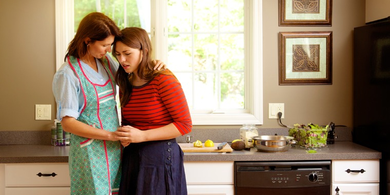 A teenage girl confiding in her mother