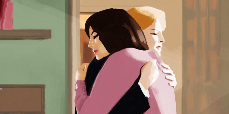 Two women embrace each other