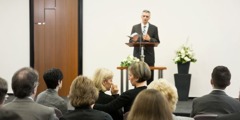 Et af Jehovas Vidner holder et foredrag ved en begravelse