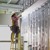 A worker checks the spacing between electrical conduits