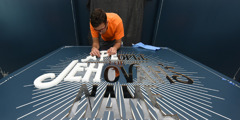 Preparing the entry sign for “A People for Jehovah’s Name” exhibit