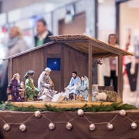 A scene depicting three wise men bringing gifts to baby Jesus