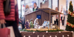 A scene depicting three wise men bringing gifts to baby Jesus