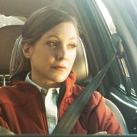 A wife angrily stares out a car window