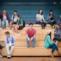 A boy who does not fit in with his peers sits alone