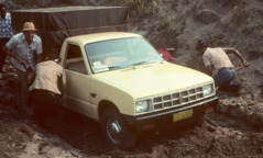 Dayrell en andere broeders graven een volgeladen auto uit de modder.