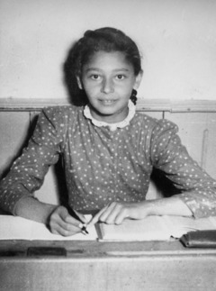 Young Elfriede sitting at her desk at school.