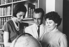 Elfriede and fellow Gilead students looking at a globe.