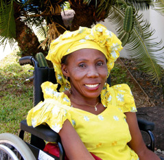 Jay Campbell smiling as she sits in her tricycle wheelchair.