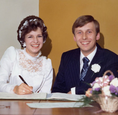 Miles and Stella posing for a picture on their wedding day.