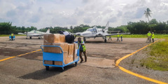 Disaster relief supplies being unloaded from two planes.