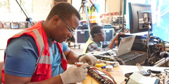 Two brothers repairing audio-video equipment.